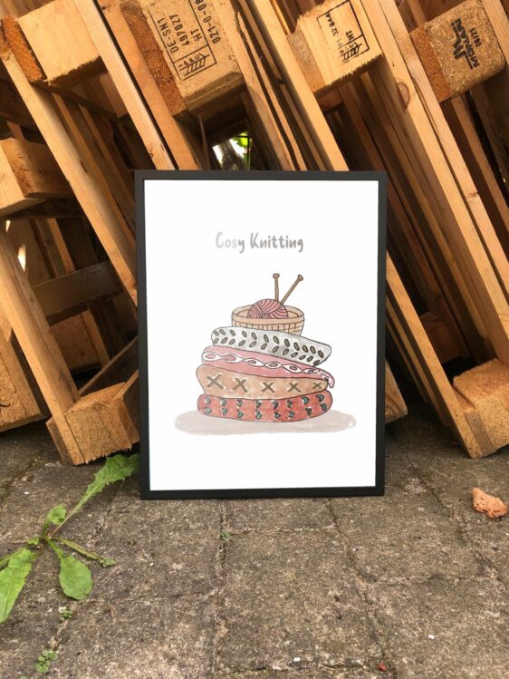 Strikkeplakat med citat, der lyder "Cozy knitting"