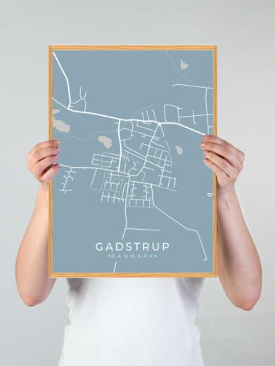 Gadstrup byplakat i lyseblå. Viser et detaljeret kort over Gadstrup, Sjælland, med hvide linjer på en lyseblå baggrund. Stilfuld vægkunst.